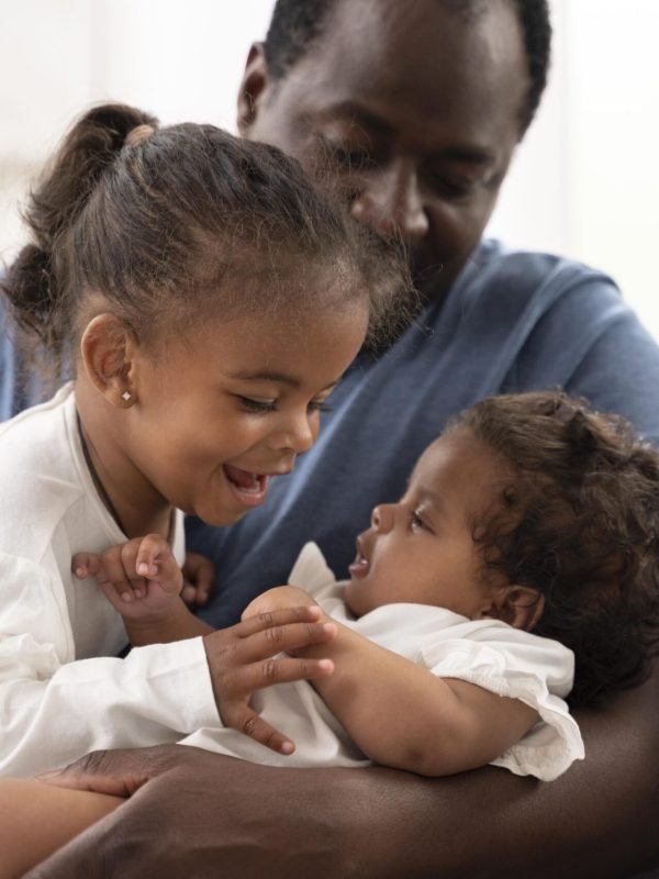 man-holding-his-daughters-his-arms